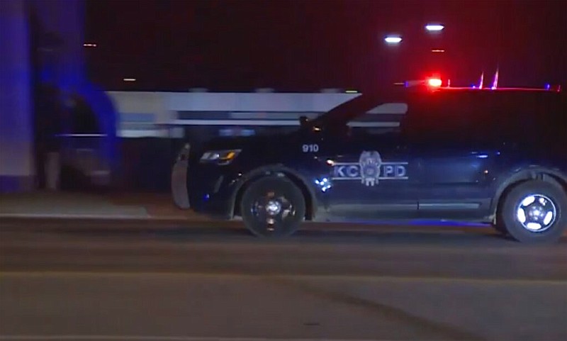 In this image made from video, a police vehicle passes with sirens near the scene of a shooting, Jan. 20, 2020, in Kansas City, Missouri. Police say at least two people are dead and upwards of a dozen people may have been injured in a shooting outside a bar. (KMBC via AP)