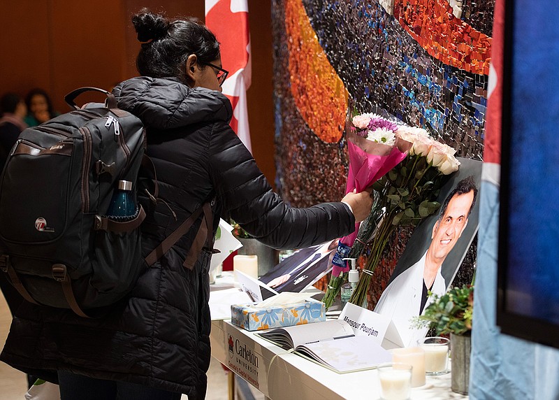 Flowers are laid beside books of condolence Wednesday before ceremony at Carleton University to honor biology Ph.D. student Fareed Arastech and biology alumnus Mansour Pourjam, who died in the crash of Ukraine International Airlines Flight PS752 in Tehran.