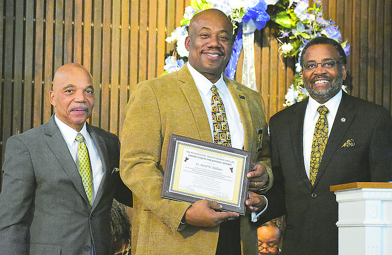 Lt. David Williams, middle, accepts the Drum Major for Justice Award at Sunday's sixth annual Martin Luther King Jr. Remembrance Ceremony at Second Baptist Church. Standing with him are the Rev. Cornell Sudduth Sr., the church pastor, left, and the Rev. W.T. Edmonson.