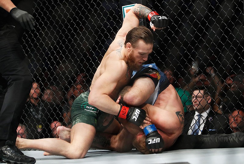  Conor McGregor, left, fights Donald "Cowboy" Cerrone during a UFC 246 welterweight mixed martial arts bout Saturday in Las Vegas. 