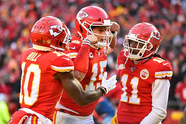 Chiefs quarterback Patrick Mahomes celebrates with Tyreek Hill and Demarcus Robinson after running for a touchdown during the first half of Sunday's AFC Championship Game against the Titans at Arrowhead Stadium in Kansas City.
