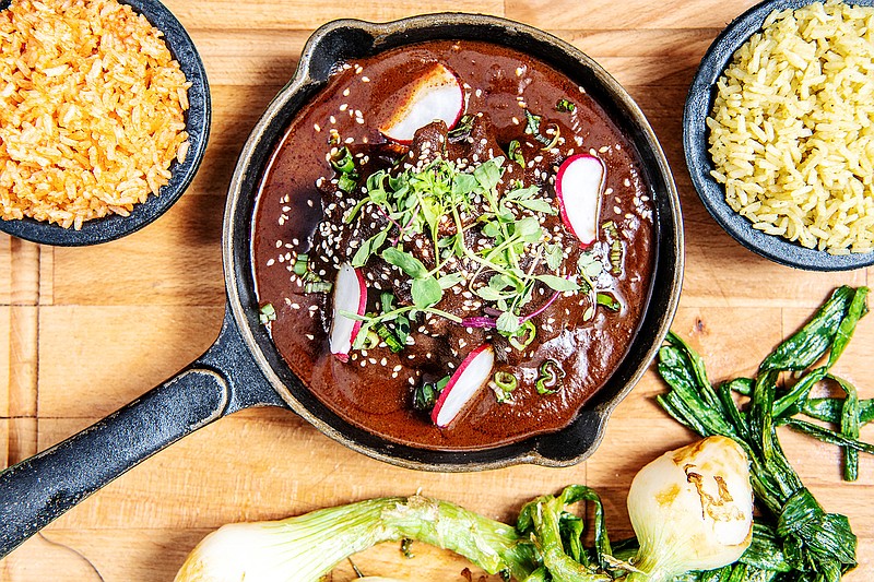 Garnish this mole with sesame seeds, fresh radishes and greens and serve with rice. (Mariah Tauger/Los Angeles Times/TNS)