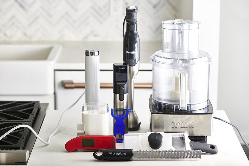 This December 2019 photo shows an assortment of various kitchen gadgets in New York, including a food processor, back right. (Cheyenne Cohen/Katie Workman via AP)