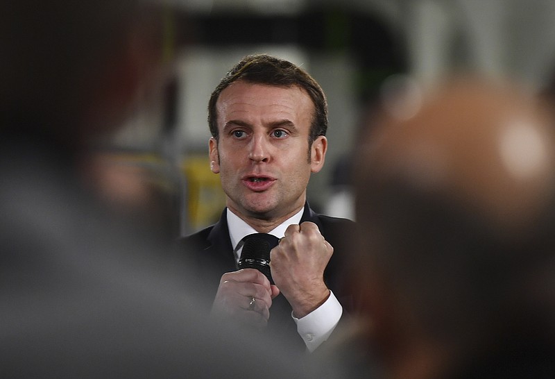 French President Emmanuel Macron delivers a speech as he visits a plant of British-Swedish pharmaceutical group Astrazeneca in Dunkirk, northern France, Monday, Monday, Jan. 20, 2020. French President Emmanuel Macron is hosting 180 international business leaders at the Palace of Versailles in a bid to promote France's economic attractiveness despite over six weeks of crippling strikes over his government's planned pension changes.(Denis Charlet/Pool Photo via AP)