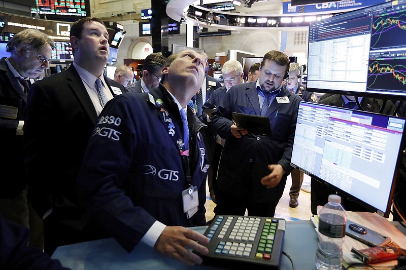 FILE - In this Jan. 15, 2020, file photo specialist Glenn Carell, center, works with traders at the post that handles NIO, a Chinese automobile manufacturer, on the floor of the New York Stock Exchange. The U.S. stock market opens at 9:30 a.m. EST on Tuesday, Jan. 21. (AP Photo/Richard Drew, File)