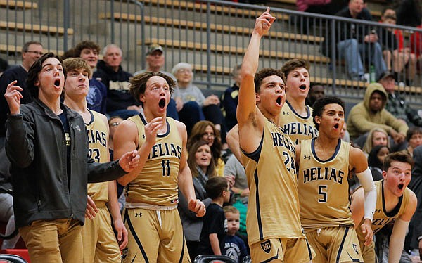 The Helias bench reacts late in Tuesday night's win against Jefferson City at Fleming Fieldhouse.
