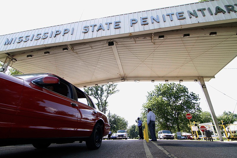  In this July 21, 2010, photo, employees leave the front gate of the Mississippi State Penitentiary in Parchman, Miss. An inmate at the Mississippi prison that was a focus of recent deadly unrest was found hanging in his cell by two corrections officers over the weekend and pronounced dead, a coroner said Sunday, Jan. 19, 2020. (AP Photo/Rogelio V. Solis, File)
