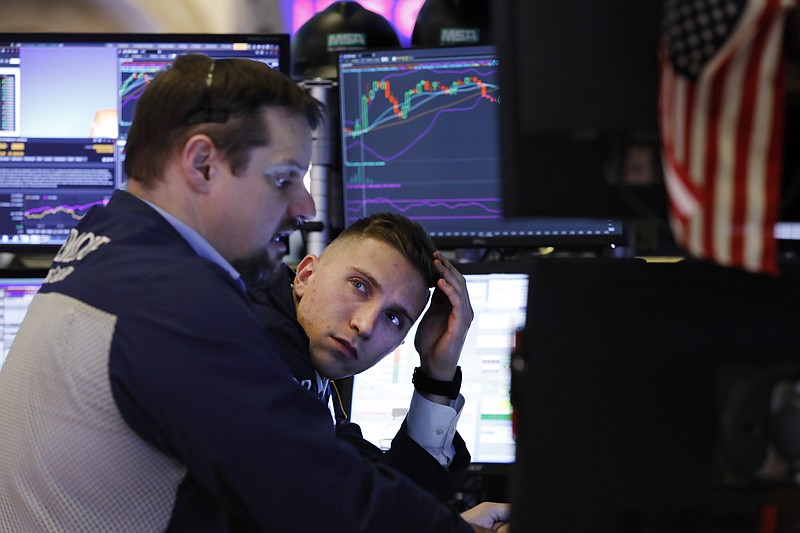 FILE - In this Jan. 15, 2020, file photo specialist Scott Vasilisin, right works with trader Michael Milano on the floor of the New York Stock Exchange. The U.S. stock market opens at 9:30 a.m. EST on Wednesday, Jan. 22. (AP Photo/Richard Drew, File)