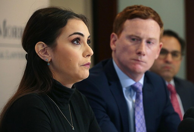 Cristen Giangarra speaks to reporters on Thursday, Jan. 23, 2020, about the night in June that she says she was raped by a Lyft driver in St. Louis. Attorney Michael Gallagher is at center.