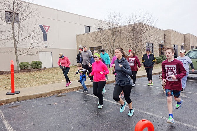 FILE: About 20 runners, including a dog, set off on the Callaway YMCA's second Hot Cocoa Hustle 5K in 2018.