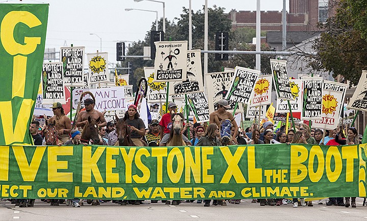 FILE - In this Aug. 6, 2017 file photo, demonstrators against the Keystone XL pipeline march in Lincoln, Neb.The Trump administration is approving a right-of-way allowing the Keystone XL oil sands pipeline to be built across U.S. land. Federal officials told The Associated Press that Interior Secretary David Bernhardt would sign the approval for about 45 miles of the line's route Wednesday, Jan. 22, 2020. It pushes the controversial $8 billion project closer to construction, but it still faces court challenges. A lawsuit challenging the pipeline is pending before a federal judge in Montana who has previously ruled against the project. The 1,200-mile pipeline would transport up to 830,000 barrels of crude oil daily from western Canada to U.S. refineries. (AP Photo/Nati Harnik, File)