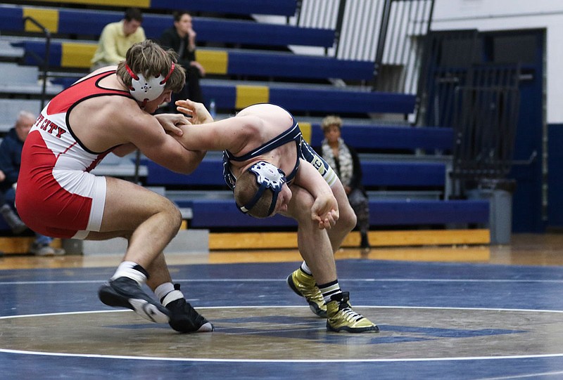 Helias' Curtis Rockers tries to twist out of the grasp of Jefferson City's Michael Friederich during a 170-pound match Wednesday at Rackers Fieldhouse. Friederich won with a first-period pin.