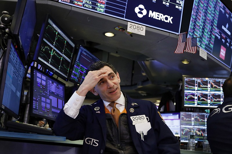 FILE - In this Jan. 15, 2020, file photo specialist Peter Mazza works at his post on the floor of the New York Stock Exchange. The U.S. stock market opens at 9:30 a.m. EST on Thursday, Jan. 23. (AP Photo/Richard Drew, File)