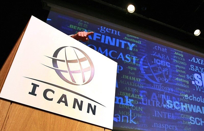 FILE- In this June 13, 2012, file photo, Rod Beckstrom, president of the Internet Corporation for Assigned Names and Numbers (ICANN), points from behind a podium during a speech in London on expanding the number of domain name suffixes. The company that controls the dot-org online universe is putting the registry of domain names up for sale. (AP Photo/Tim Hales, File)