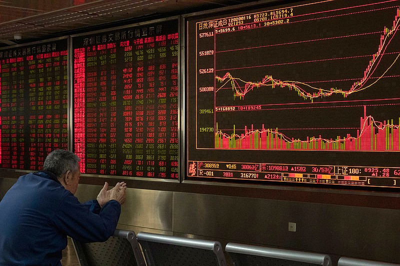 In this Jan. 16, 2020, file photo, an investor monitors stock prices at a brokerage in Beijing. Several factors are pointing to a possible rebound in emerging market stocks this year. Stocks in China and other developing economies notched solid gains in 2019, but lagged the blockbuster market returns delivered by publicly traded companies in the U.S. and other developed economies. (AP Photo/Ng Han Guan, File)