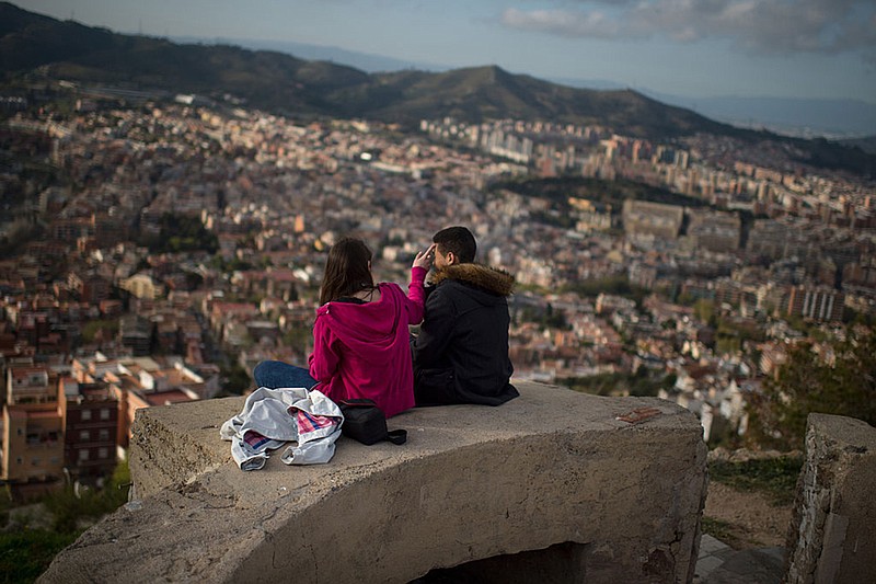 A couple enjoy the views over the city from old anti-aircraft batteries built to defend the city during the Spanish Civil war on April 10, 2015 in Barcelona, Spain. (David Ramos/Getty Images/TNS)