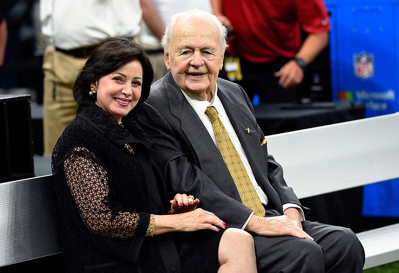 In this Sept. 17, 2017, file photo, New Orleans Saints owner Tom Benson sits on the sideline with his wife, Gayle Benson, before an NFL football game in New Orleans. Attorneys for several men suing the Roman Catholic church say documents they obtained through discovery show that the New Orleans Saints team aided the Archdiocese of New Orleans in its "pattern and practice of concealing its crimes."  (AP Photo/Bill Feig, File)