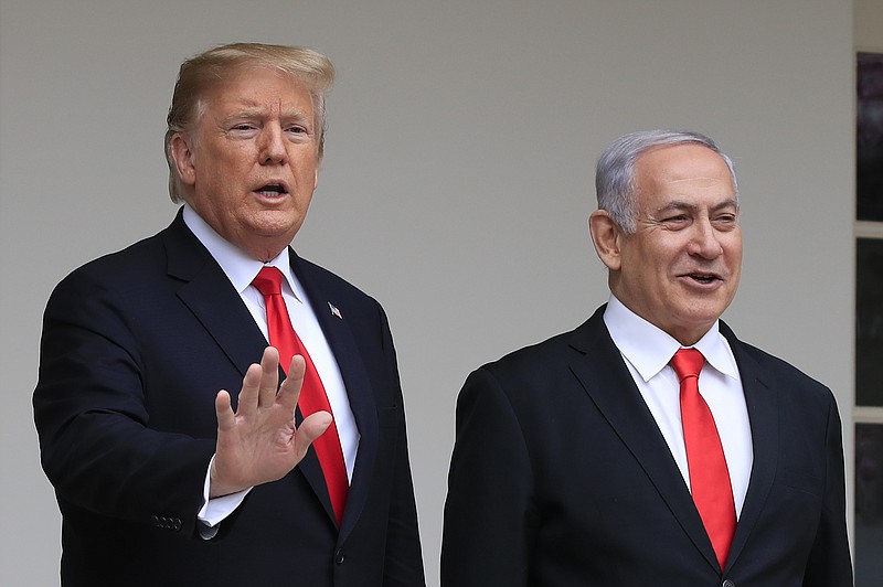 FILE - In this March 25, 2019, file photo, President Donald Trump welcomes visiting Israeli Prime Minister Benjamin Netanyahu to the White House in Washington. A blueprint the White House is rolling out to resolve the decades-long conflict between the Israelis and Palestinians is as much about politics as it is about peace. President Donald Trump said he would likely release his long-awaited Mideast peace plan a little before he meets Tuesday with Israeli Prime Minister Benjamin Netanyahu and his main political rival Benny Gantz. (AP Photo/Manuel Balce Ceneta, File)