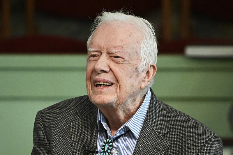 FILE - In this Nov. 3, 2019, file photo, former President Jimmy Carter teaches Sunday school at Maranatha Baptist Church in Plains, Ga. Sunday school teacher Kim Fuller makes a point during class and the old man sitting on the front pew raises his eyebrows quizzically.  That old man is her uncle, former president Jimmy Carter and Fuller's unique challenge is to serve as his substitute in the class he usually teaches himself. Fuller is the eldest daughter of Carter’s late brother Billy Carter, and she has served as the regular replacement for the world’s best-known Sunday school teacher since Carter underwent brain surgery in November. (AP Photo/John Amis, File)