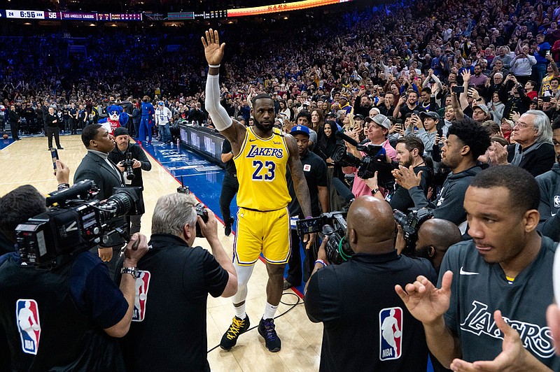 LeBron James of the Lakers reacts after moving to No. 3 on the NBA's career scoring list during the second half of Saturday night's game against the 76ers in Philadelphia. 