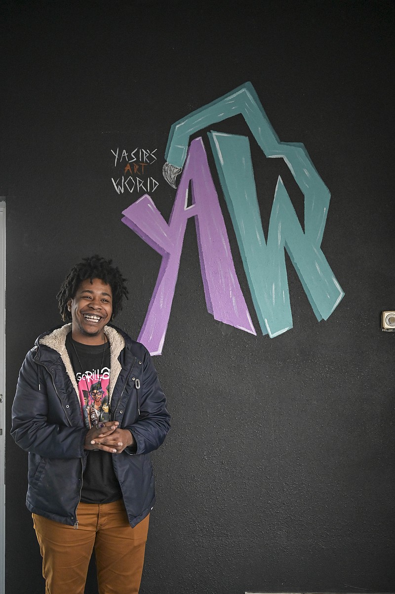Yasir DeGrate poses for a portrait next to his logo in his new art studio, Yasir's Art World on 3420 N. State Line Ave. in Texarkana, Arkansas. 