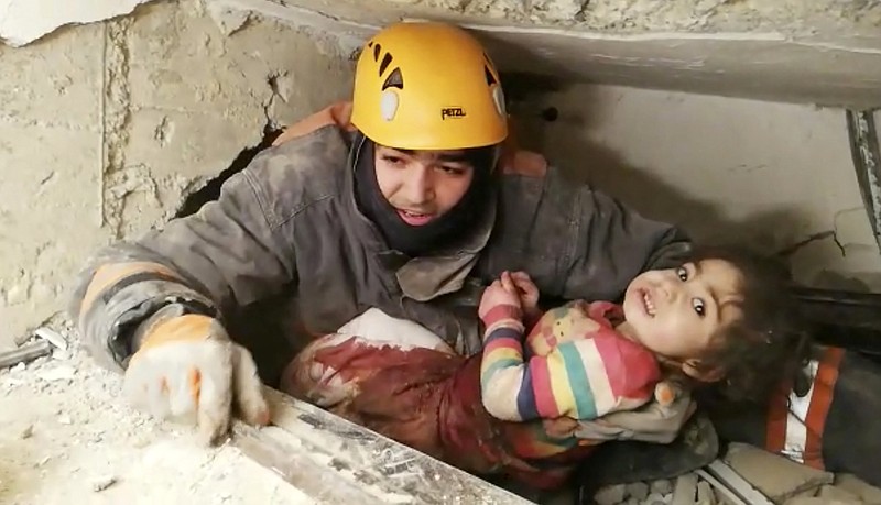 In this image taken from video made available by Ankara Municipality Fire Department shows a rescuer pulling out a girl from the rubble of a collapsed building, in Elazig, Turkey, Saturday Jan. 25, 2020. A two-year-old girl and her mother were pulled from the rubble of an apartment building on Saturday more than 24 hours after an earthquake struck eastern Turkey. Various earthquake monitoring centres gave magnitudes of the quake ranging from 6.5 to 6.8. (Ankara Municipality Fire Department via AP)