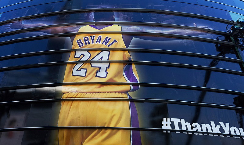 A giant banner congratulating Kobe Bryant is draped around Staples Center before his last NBA basketball game, a contest against the Utah Jazz, on April 13, 2016, in downtown Los Angeles. Bryant, a five-time NBA champion and a two-time Olympic gold medalist, died in a helicopter crash in California on Sunday. He was 41. 