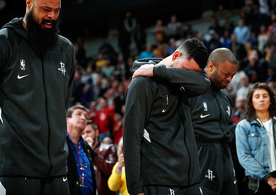 (From left) Rockets teammates Tyson Chandler, Austin Rivers and P.J. Tucker react during a tribute to Kobe Bryant before Sunday's game against the Nuggets in Denver.