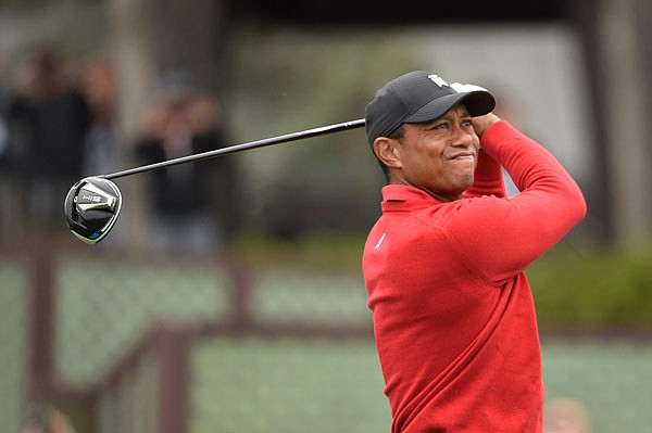 Tiger Woods hits his tee shot on the first hole of Sunday's final round of the Farmers Insurance Open in San Diego.