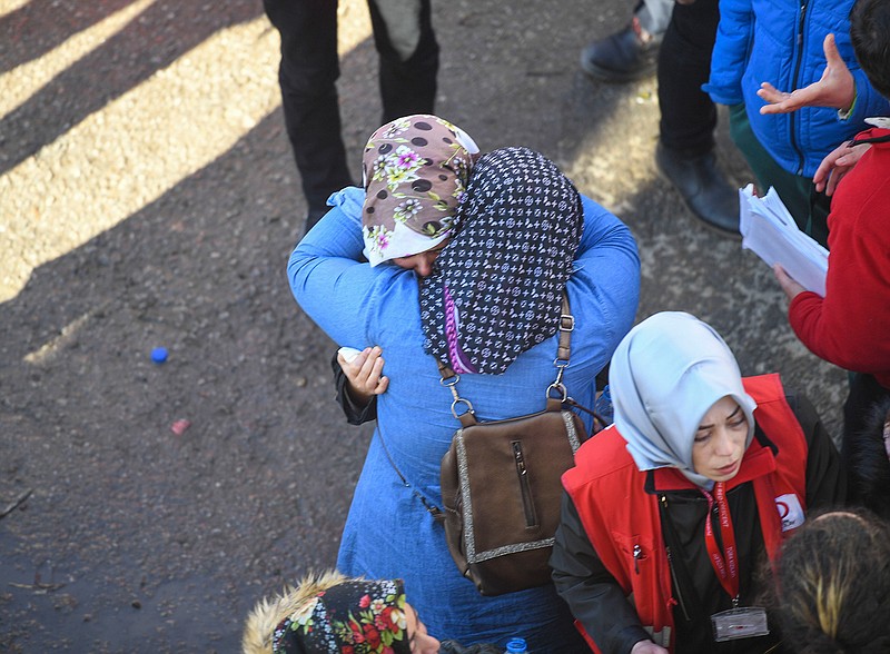 Two women embrace as rescue workers try to save people trapped under debris following a strong earthquake that destroyed several buildings on Friday, in Elazig, eastern Turkey, Sunday, Jan. 26, 2020. Working against the clock in freezing temperatures, Turkish rescue teams pulled more survivors from collapsed buildings Sunday, days after a powerful magnitude 6.8 earthquake hit the country's east. (AP Photo)