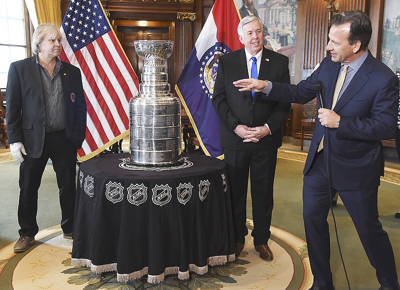 Chris Zimmermanat, right, points out Philip Pritchard, left, and says how happy he is for Pritchard to be at the Capitol on Monday with the Lord Stanley Cup. Zimmerman is president and CEO of Business Operations for the St. Louis Blues and Pritchard is the Stanley Cup handler for the Hockey Hall of Fame in Toronto, Canada. They were in Gov. Mike Parson's Capitol office Monday before taking the trophy to the Rotunda for the public to see it.