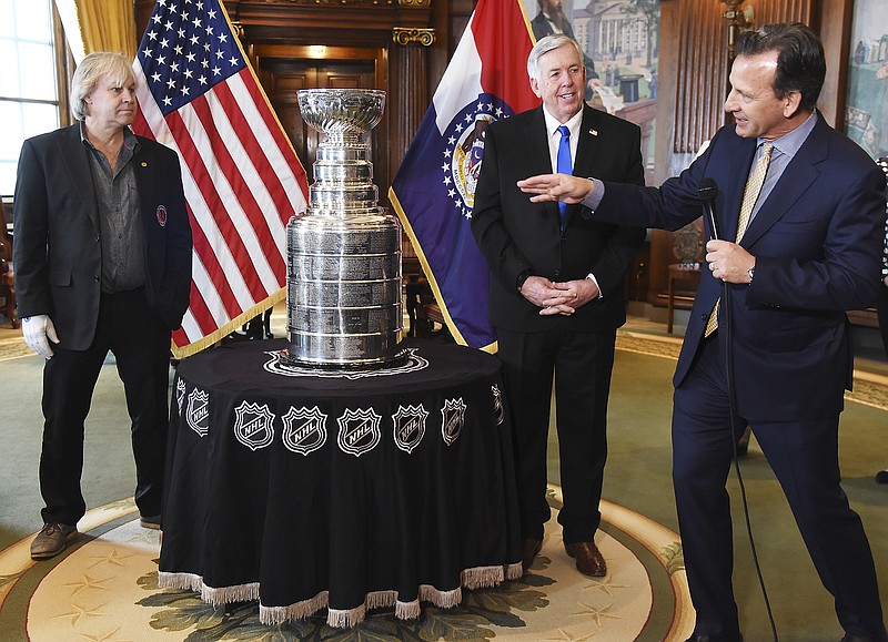 Chris Zimmerman, right, points out Philip Pritchard, at left, and says how happy he is for Pritchard to be at the Capitol on Monday with the Lord Stanley Cup. Zimmerman is president and CEO of business operations for the St. Louis Blues. Pritchard is the Stanley Cup handler for the Hockey Hall of Fame in Toronto, Canada. They were in Gov. Mike Parson's Capitol office Monday before taking the trophy to the Rotunda for the public to see it.