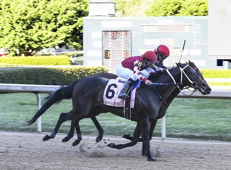 Midnight Bisou (6), ridden by Mike Smith, and Escape Clause, under by Tyler Baze, battle it out to the finish for the running of the Apple Blossom Handicap at Oaklawn Park on Sunday, April 14, 2019. (Photo by Grace Brown of The Sentinel-Record)