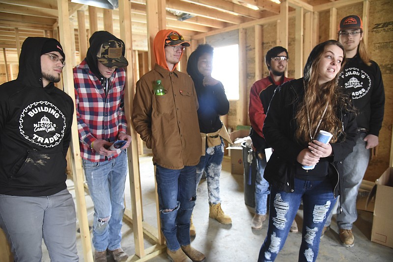 River City Habitat for Humanity hosted a "Blessing of the Build" on Tuesday at a house currently under construction at 317 E. Ashley St. The new house will be home to Nikki Rapier, foreground right, and her daughter, younger brother and her mother. Upon her arrival, Rapier walked over to thank the students from Nichols Career Center Building Trades Class for their work on the one-story house. 