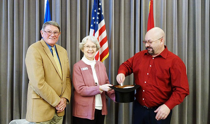 The Kingdom of Callaway Historical Society's Joe Holt, left, and Diane Burre Ludwig grin while Fulton Mayor Lowe Cannell picks a president. Each year, Fulton's mayor is tasked with drawing a president to be featured in the historical society's annual President's Day Trivia Night.