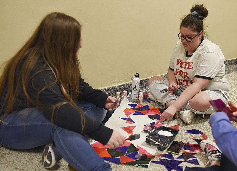 <p>Claire Hassler/News Tribune</p><p>From left, Courtney Hudson and Mikayla Gaggens make a stained glass window for the set during play rehearsal for “CLUE” on Monday at the Miller Performing Arts Center. Hudson and Gaggens are both seniors at Jefferson City High School.</p>