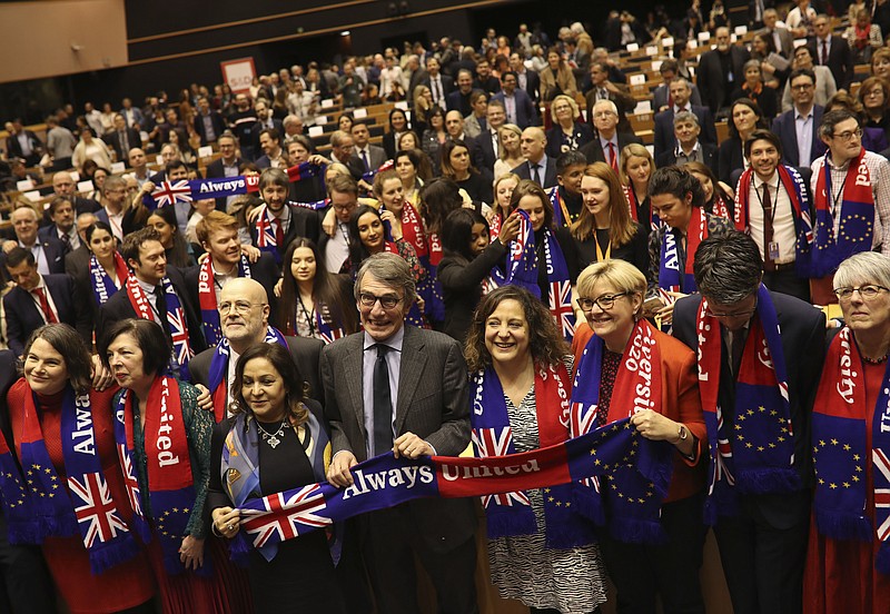 European Parliament President David Sassoli, center, stands with other British MEP's and members of the political group Socialist and Democrats as they participate in a ceremony prior to the vote on the UK's withdrawal from the EU at the European Parliament in Brussels, Wednesday, Jan. 29, 2020. The U.K. is due to leave the EU on Friday, Jan. 31, 2020, the first nation in the bloc to do so. (AP Photo/Francisco Seco)