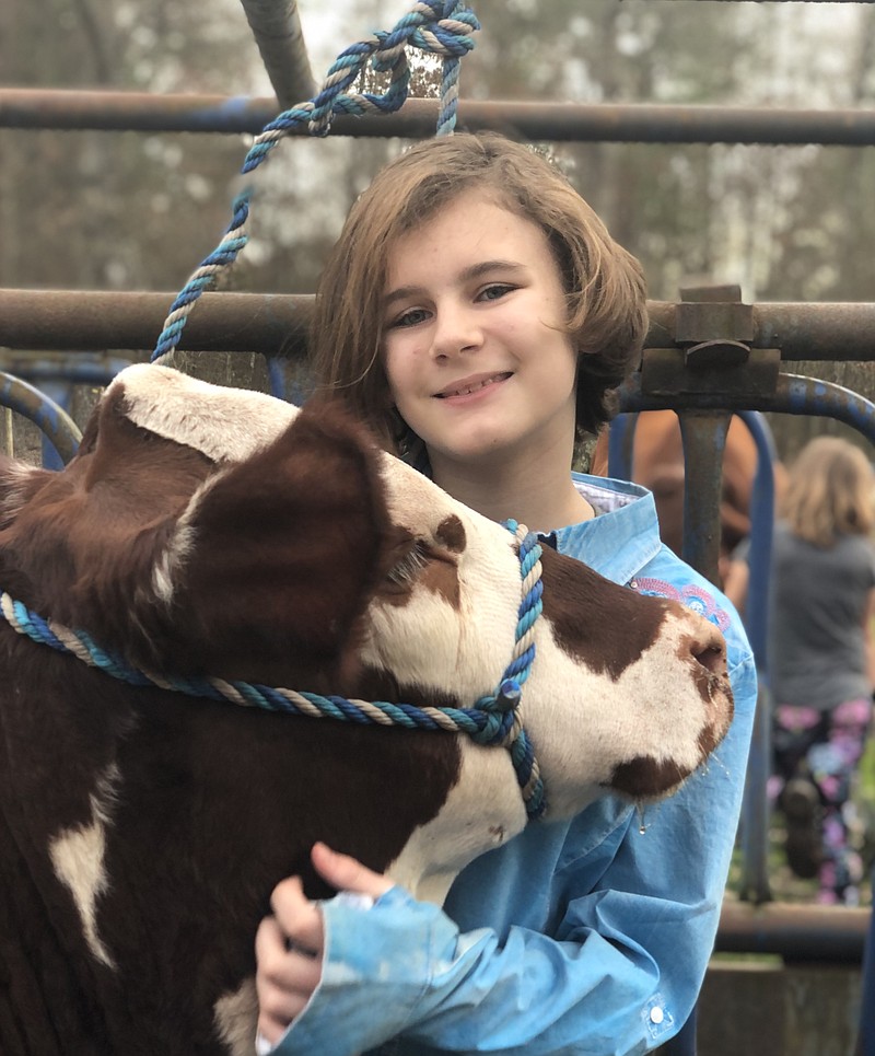 Cydnee-Ann Presson poses with her show cow, Lucinda, a week after Lucinda was named the Grand Champion Star Five Female on Jan. 19 at the National Santa Gertrudis Show at the Fort Worth Stock Show and Rodeo. (Photo by Karen McConaughey)
