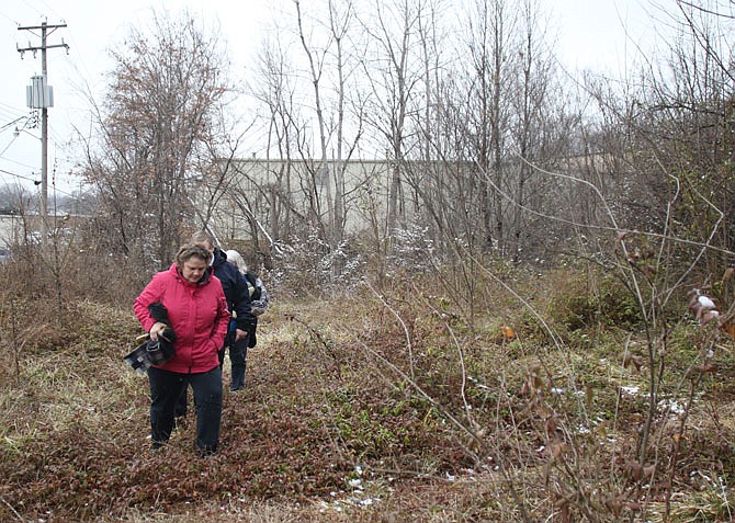 Tina Mollencamp leads the way back to the car Wednesday, Jan. 29, 2020, after finding evidence of outdoor camping out in the brush behind the Dollar General on Missouri Boulevard. Though they found no one to talk to, they did find some evidence of homeless camps around Jefferson City and they said lots of folks showed up to The Salvation Army and were surveyed. 