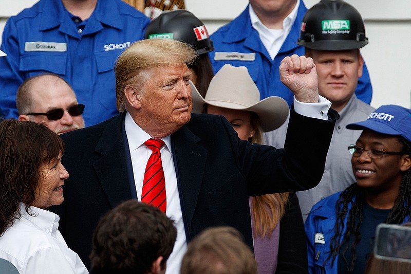 President Donald Trump pumps his fist after signing a new North American trade agreement with Canada and Mexico, during an event at the White House, Wednesday, Jan. 29, 2020, in Washington. (AP Photo/Alex Brandon)