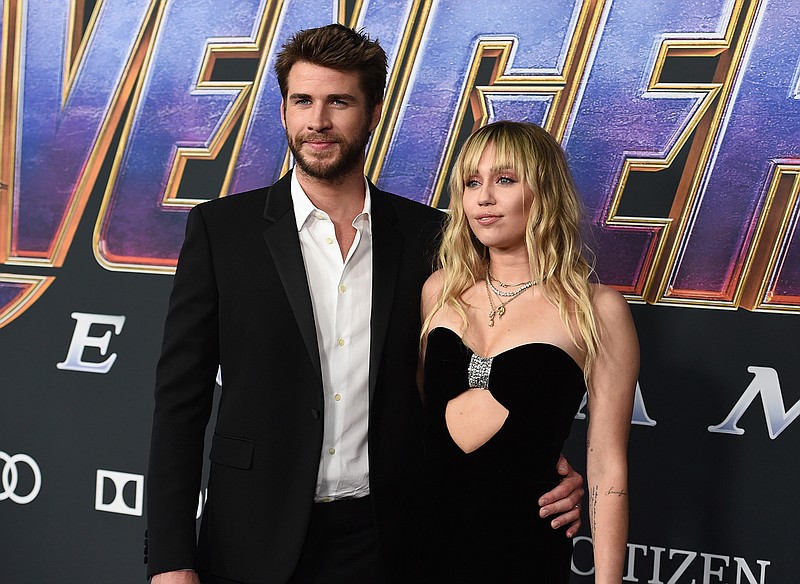 This April 22, 2019 file photo shows Liam Hemsworth, left, and Miley Cyrus arrive at the premiere of "Avengers: Endgame" in Los Angeles. Cyrus and Hemsworth are legally single. Court records show that a Los Angeles judge on Tuesday, Jan. 28, 2020, finalized the divorce that ended the brief marriage. The couple separated and Hemsworth filed for divorce in August, about eight months after he and Cyrus married. (Photo by Jordan Strauss/Invision/AP, File)