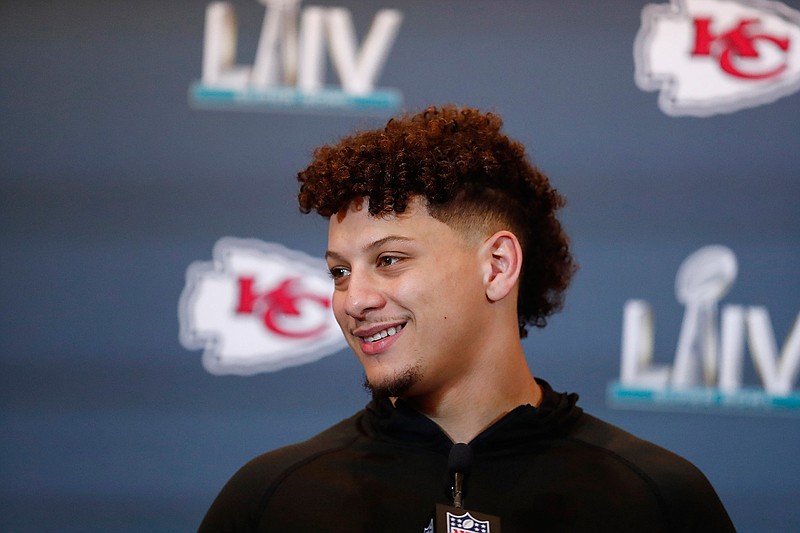 Kansas City Chiefs quarterback Patrick Mahomes (15) speaks during a news conference on Wednesday, Jan. 29, 2020, in Aventura, Fla., for the NFL Super Bowl 54 football game. (AP Photo/Brynn Anderson)