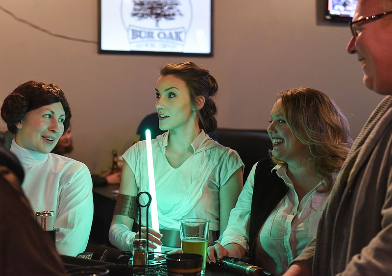 Claire Hassler/News Tribune
From left, Whitney Payne, Rachel Murphy, Jessica Crump and Josh Fork socialize and drink beer during the Bar Wars pub crawl on Saturday, February 1, 2020 at J Pfenny’s Sports Grill and Pub in downtown Jefferson City. Payne and Murphy are part of Rotaract, a service organization for young professionals, and the bar crawl was Rotaract’s social activity for this month.