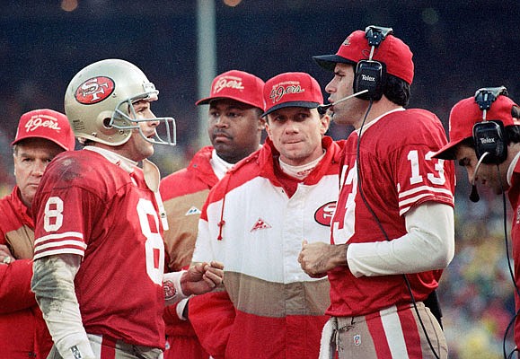 In this Jan. 18, 1993, file photo, San Francisco quarterbacks (from left) Steve Young, Joe Montana and Steve Bono talk in the final minutes of the NFC Championship Game against the Cowboys in San Francisco. Montana and Bono were both later starting quarterbacks for the Chiefs.