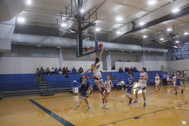 <p>Democrat photo/Kevin Labotka</p><p>Trevor Myers attempts a dunk during the Pintos’ 93-64 win over Wright City in the seventh place game of the Hermann tournament Feb. 1.</p>