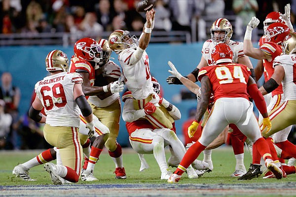 Frank Clark of the Chiefs tries to tackle 49ers quarterback Jimmy Garoppolo late in Sunday night's game in Miami Gardens, Fla.
