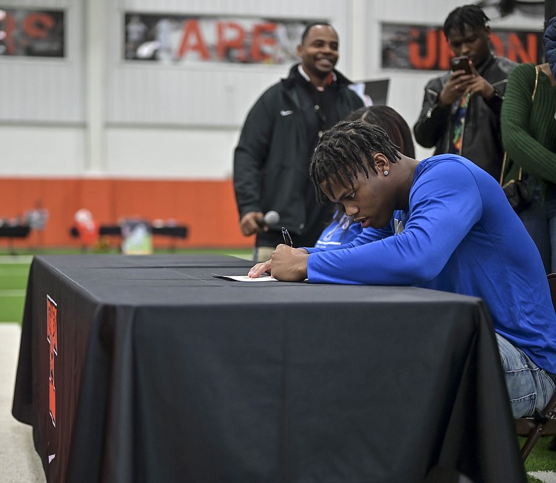 Staff photo by Hunt Mercier
Kobe Webster signs his acceptance letter to play football at the University of Memphis at Texas High School indoor football practice field on Wednesday, February 5, 2020, in Texarkana, Texas. Wednesday was National Signing Day across the country where students signed their acceptance letters to colleges. 