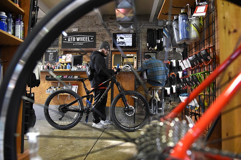 <p>Jenna Kieser/News Tribune</p><p>Steven Mansean stands with his bike inside Red Wheel Bike Shop before the start of the 2019 Bicycle Pub Crawl. The annual crawl is set for 4 p.m. Saturday, with participants expected to meet at Red Wheel Bike Shop before moving to four different bars throughout town.</p>