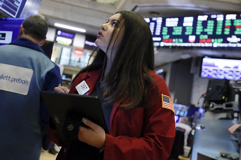 Trader Ashley Lara works on the floor of the New York Stock Exchange, Wednesday, Feb. 5, 2020. Stocks are opening broadly higher on Wall Street, putting the market on track for a third straight day of solid gains. (AP Photo/Richard Drew)