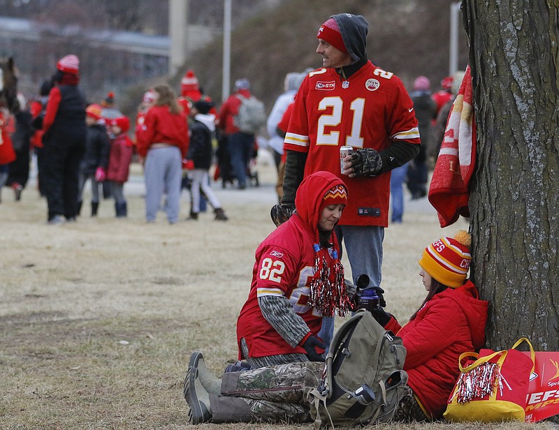 Liv Paggiarino/News Tribune

Chris Woodring, top, Kelly Woodring, left, and Misty McCorkle hang around their selected viewing spot for the Kansas City Chiefs’ Super Bowl champions celebration parade on Wednesday on the lawn of the World War I Memorial in Kansas City. The group is all from Kansas City.
